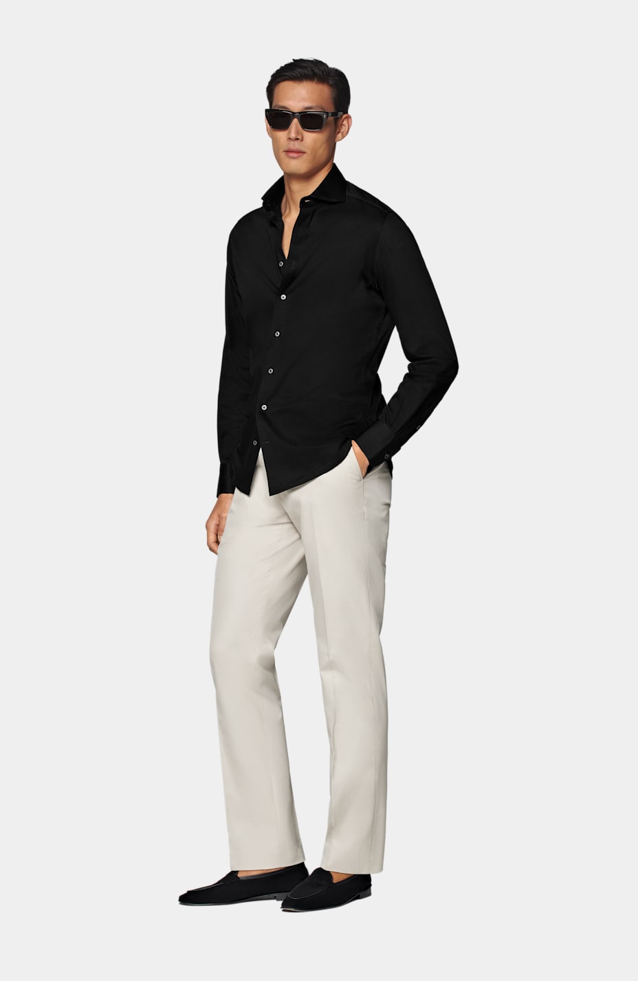 Indian Man At Black Shirt And Beige Pants Posed At Field. Stock Photo,  Picture and Royalty Free Image. Image 131317034.