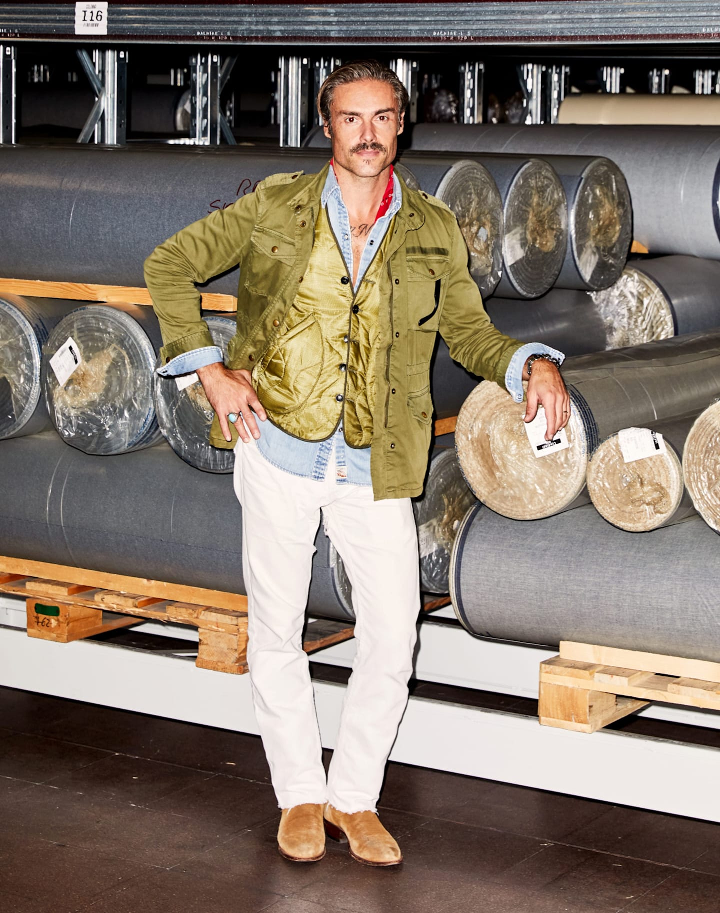 Candiani Global Marketing Director Simon Giuliani stands in front of finished fabric rolls.