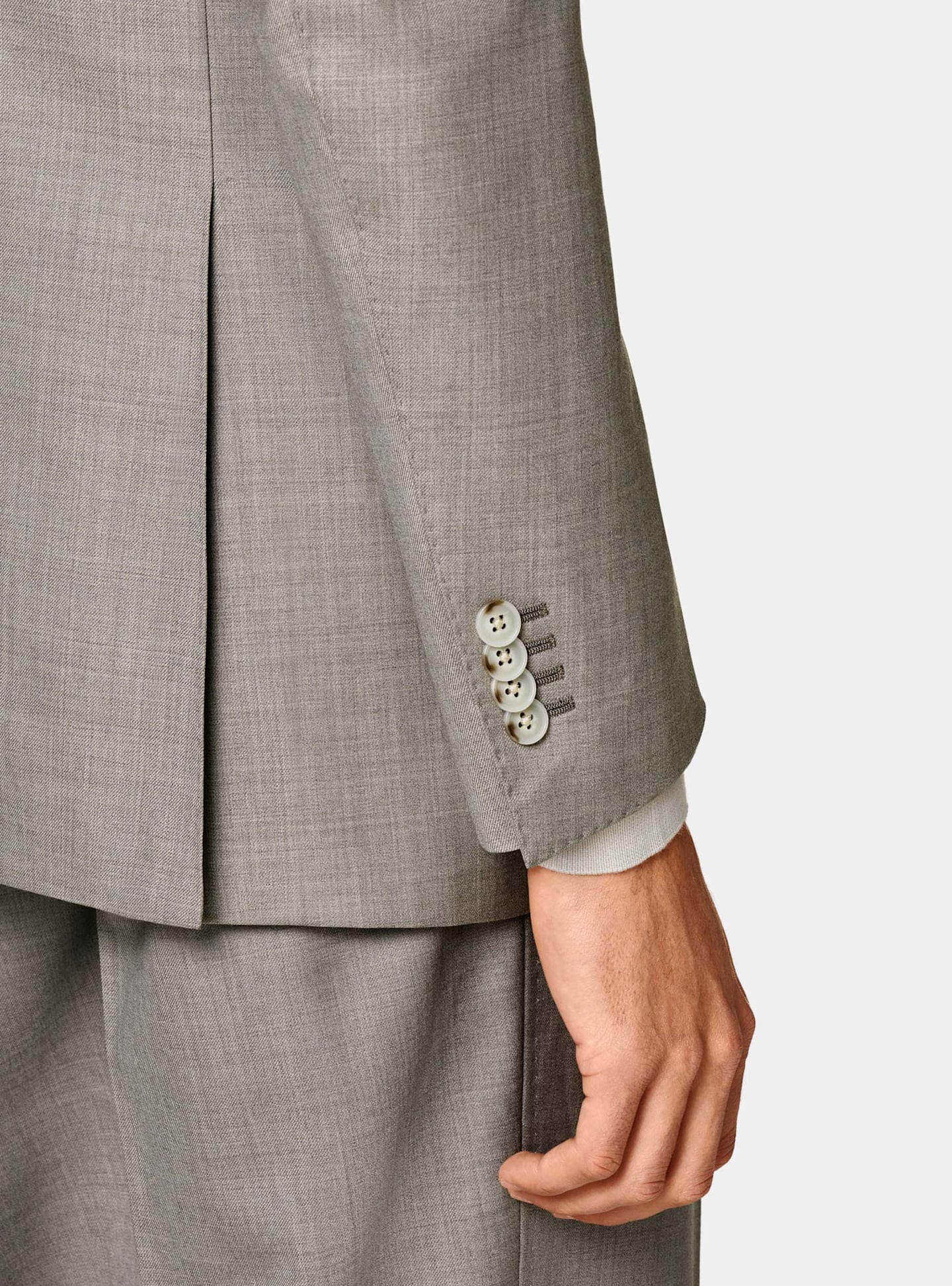 Detail of taupe single-breasted suit sleeve.