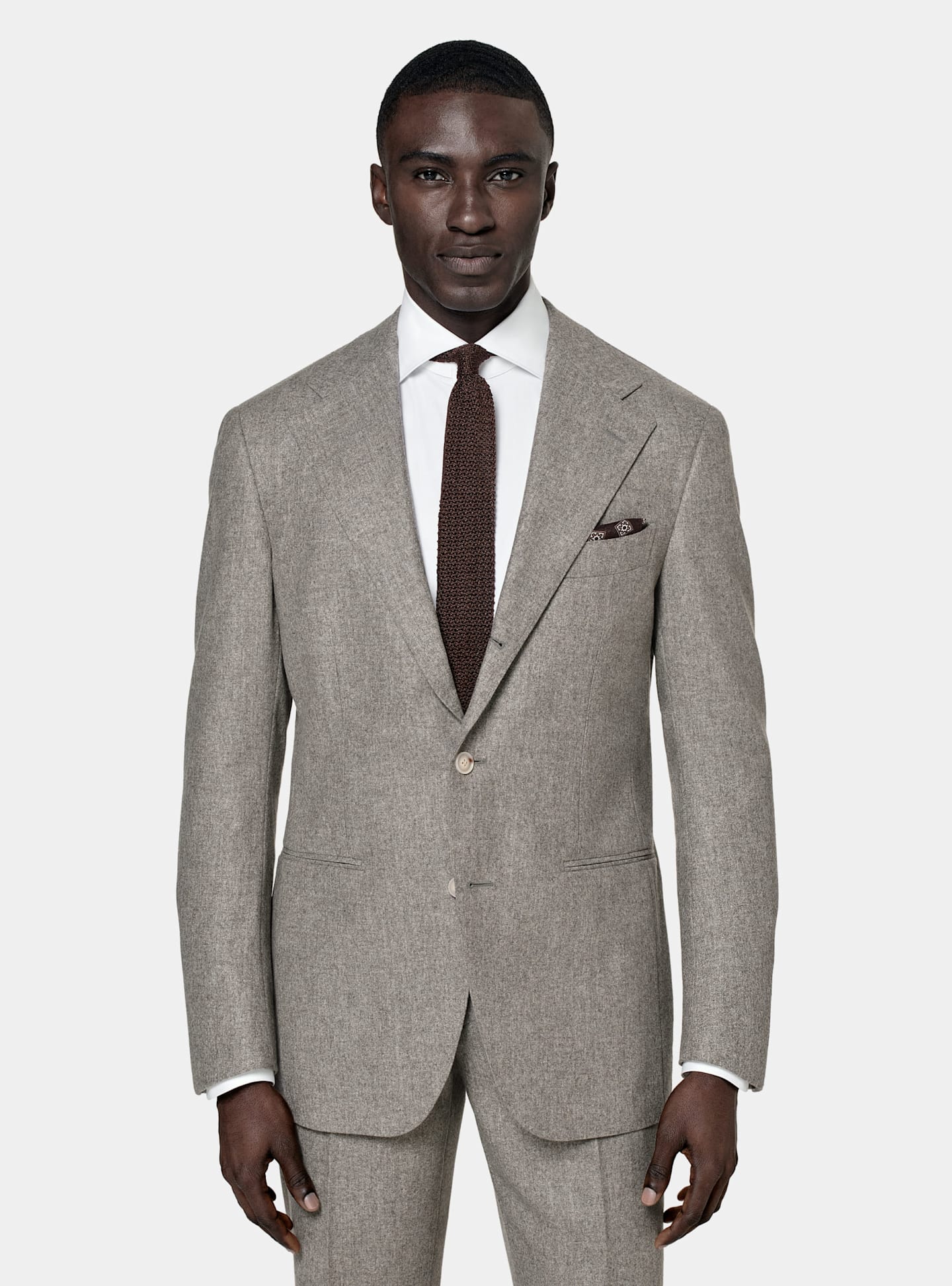 Grey single-breasted suit with brown knitted silk tie and pocket square.