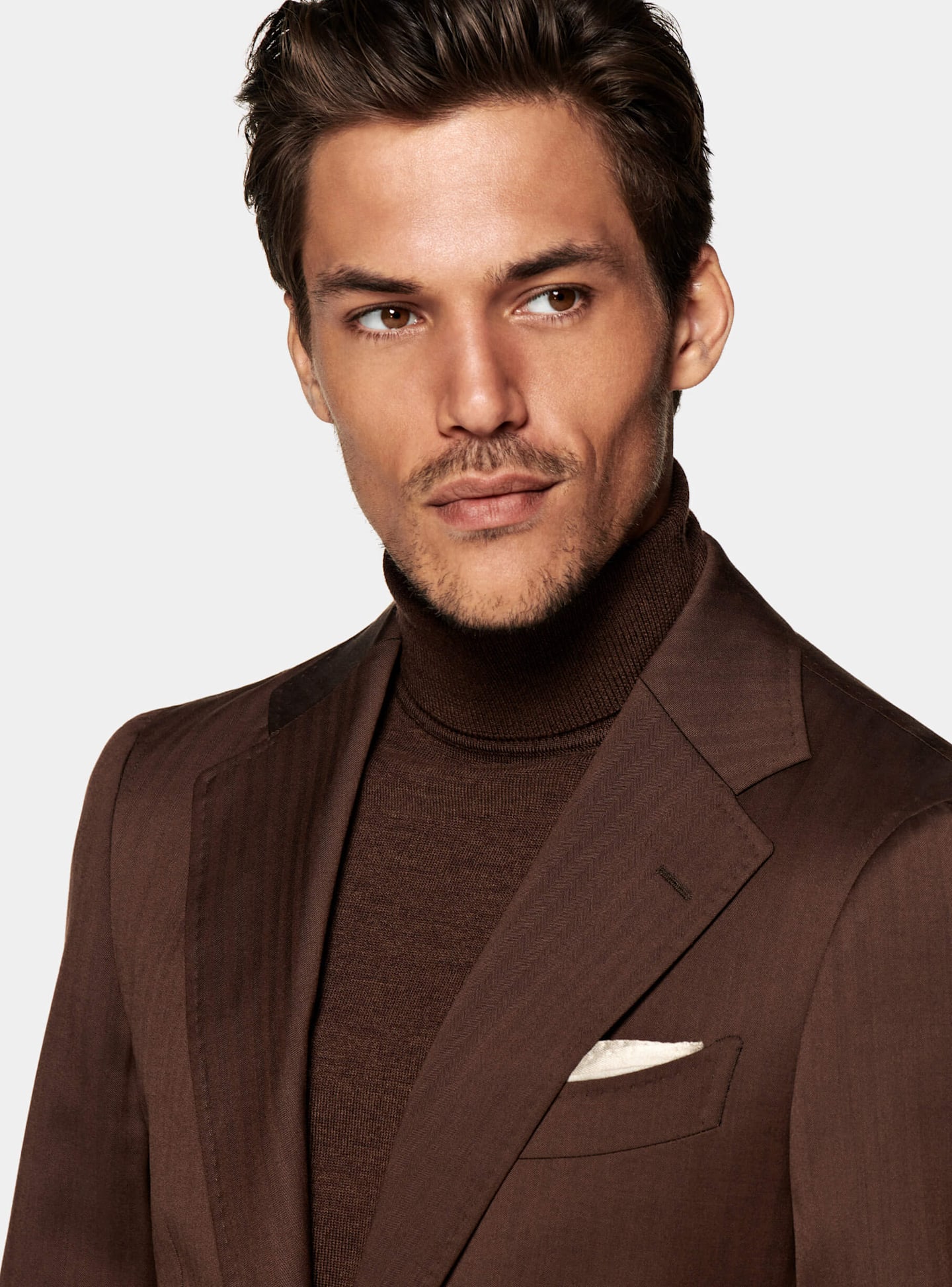 Zoomed image of the Brown Havana Suit paired with a silk turtle neck and a white pocketsquare.