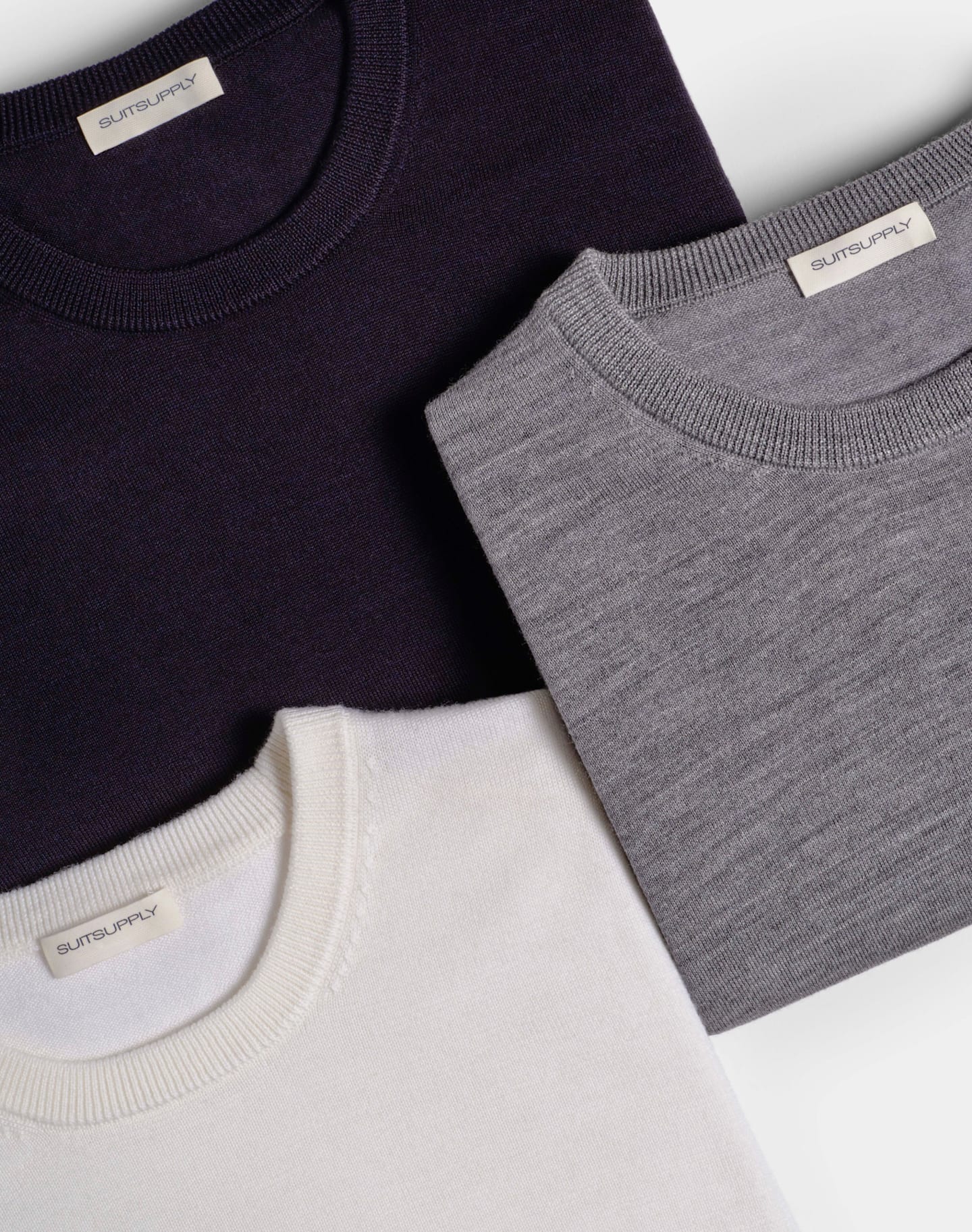 Three pure wool crewneck sweaters