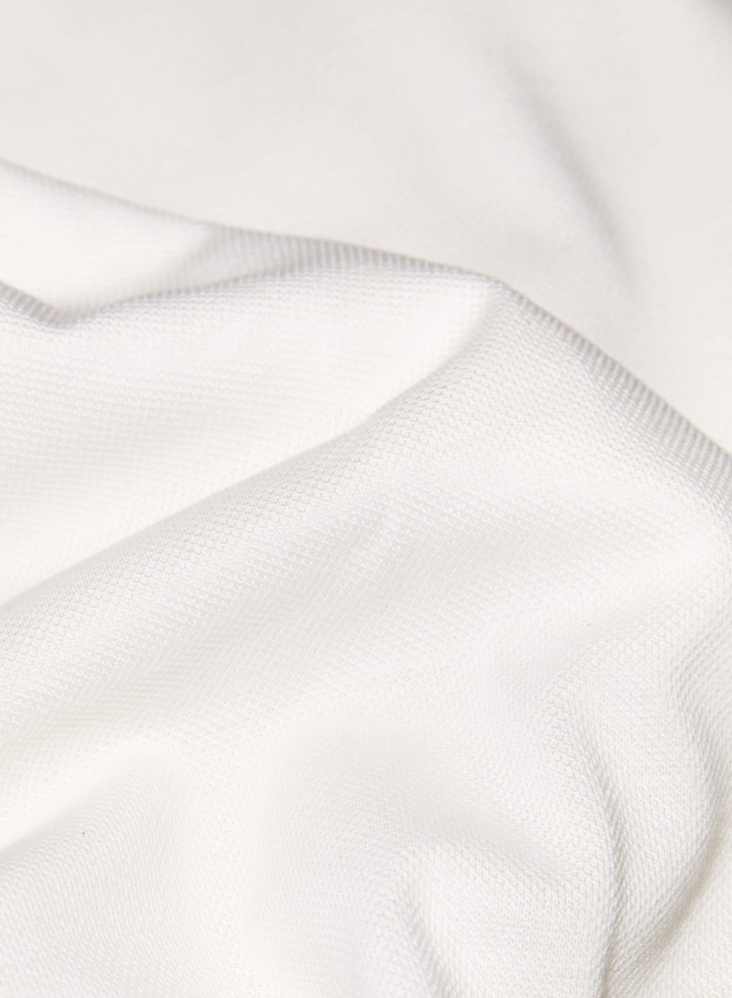 Suitsupply white pique fabric primarily used for polo shirts.
