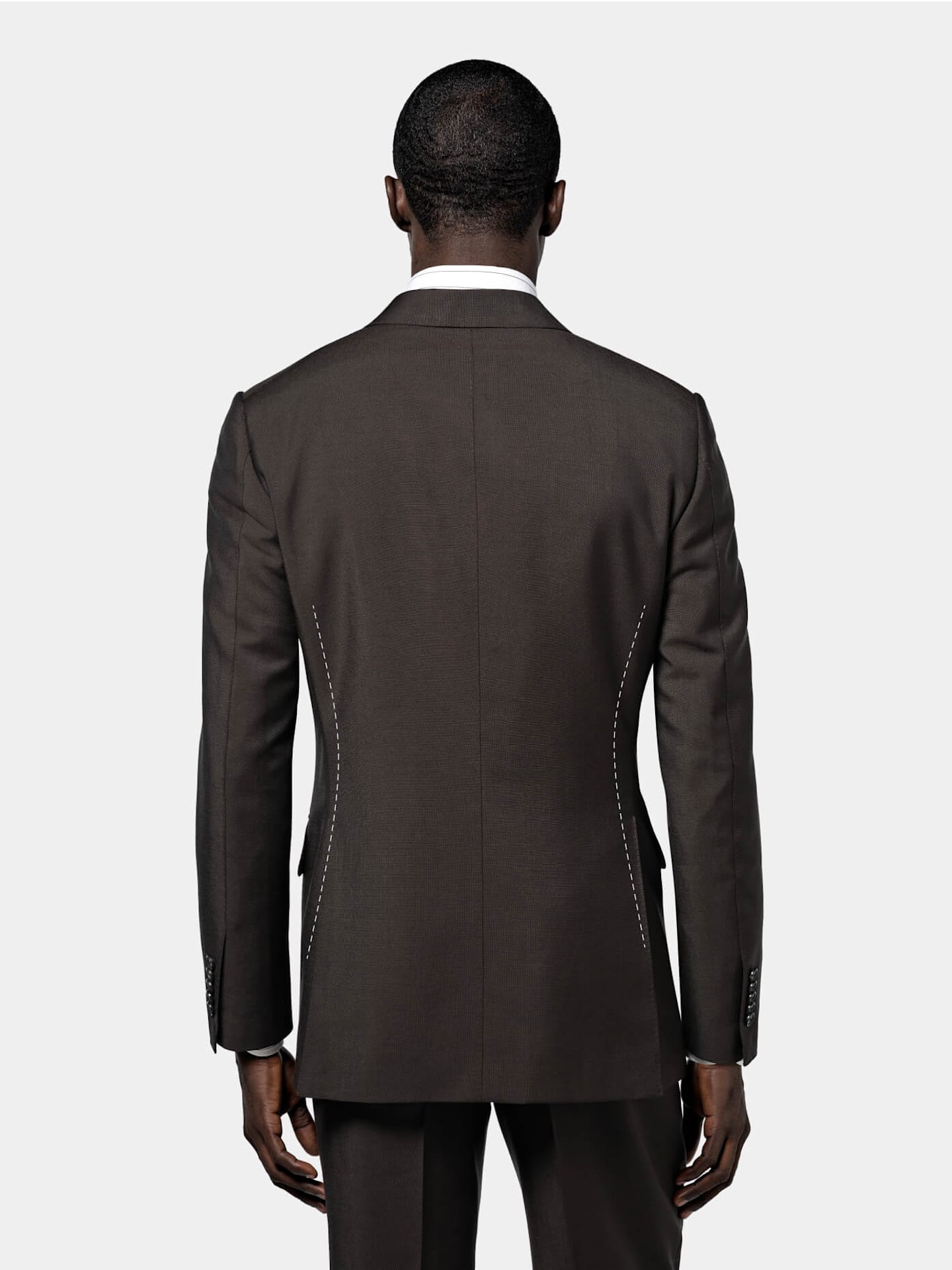 A man in a suit is depicted from the back, highlighting his formal attire and poised demeanor.