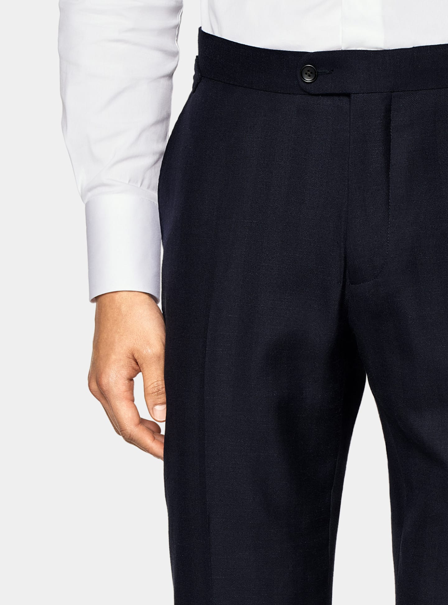 A zoomed in photo featuring kissing buttons on a navy formal suit.