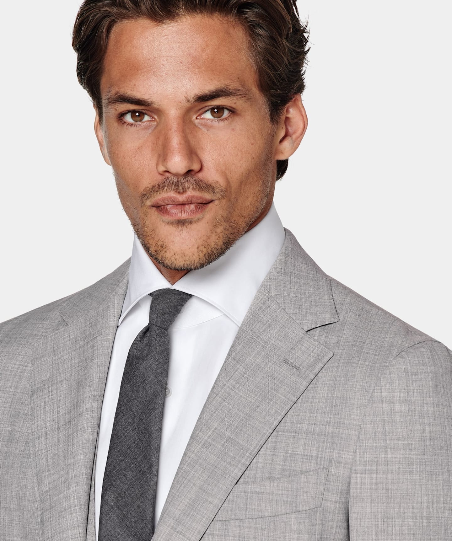 Grey suit jacket styled with white shirt and grey tie