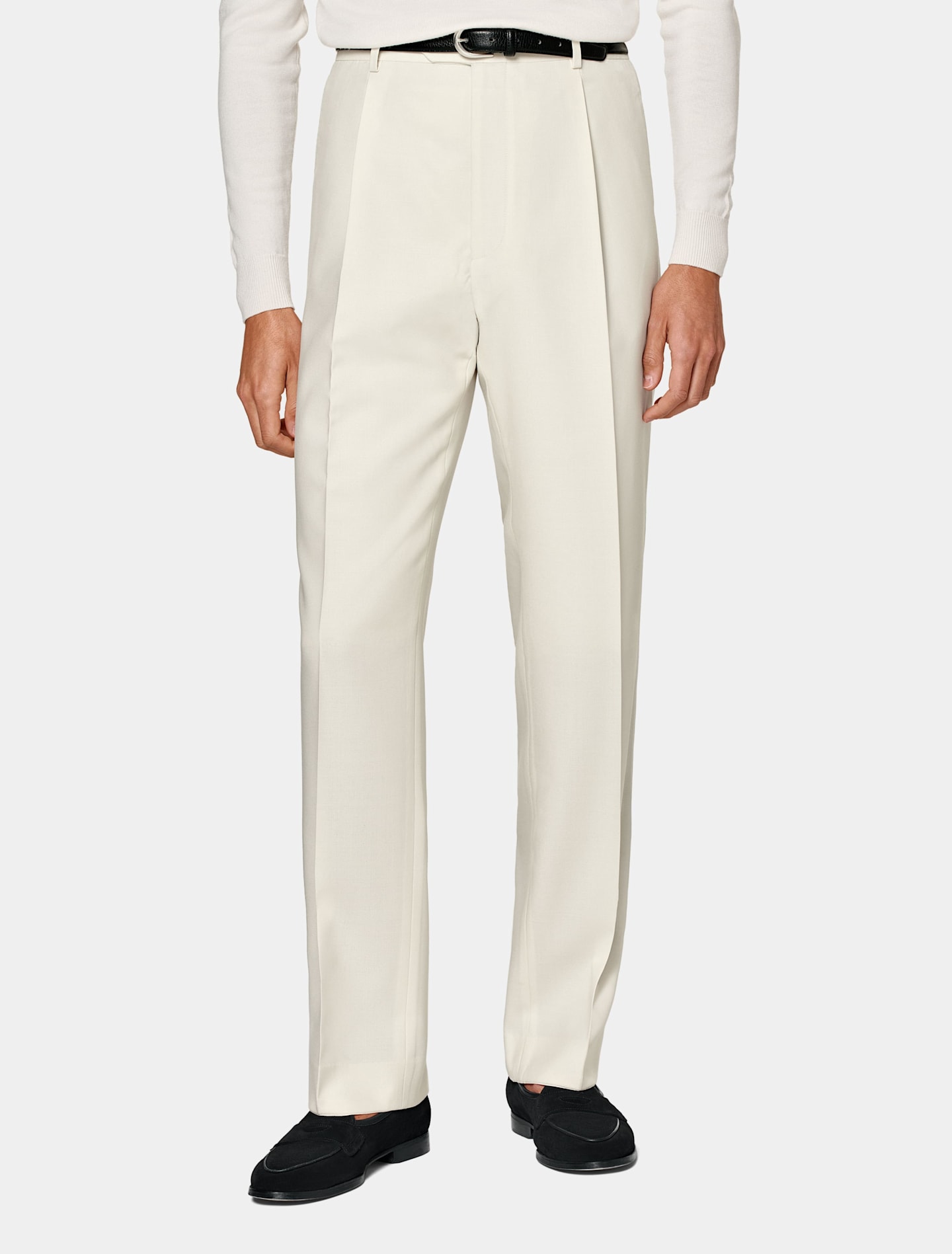 Off-white straight-fit trousers with black belt and loafers.