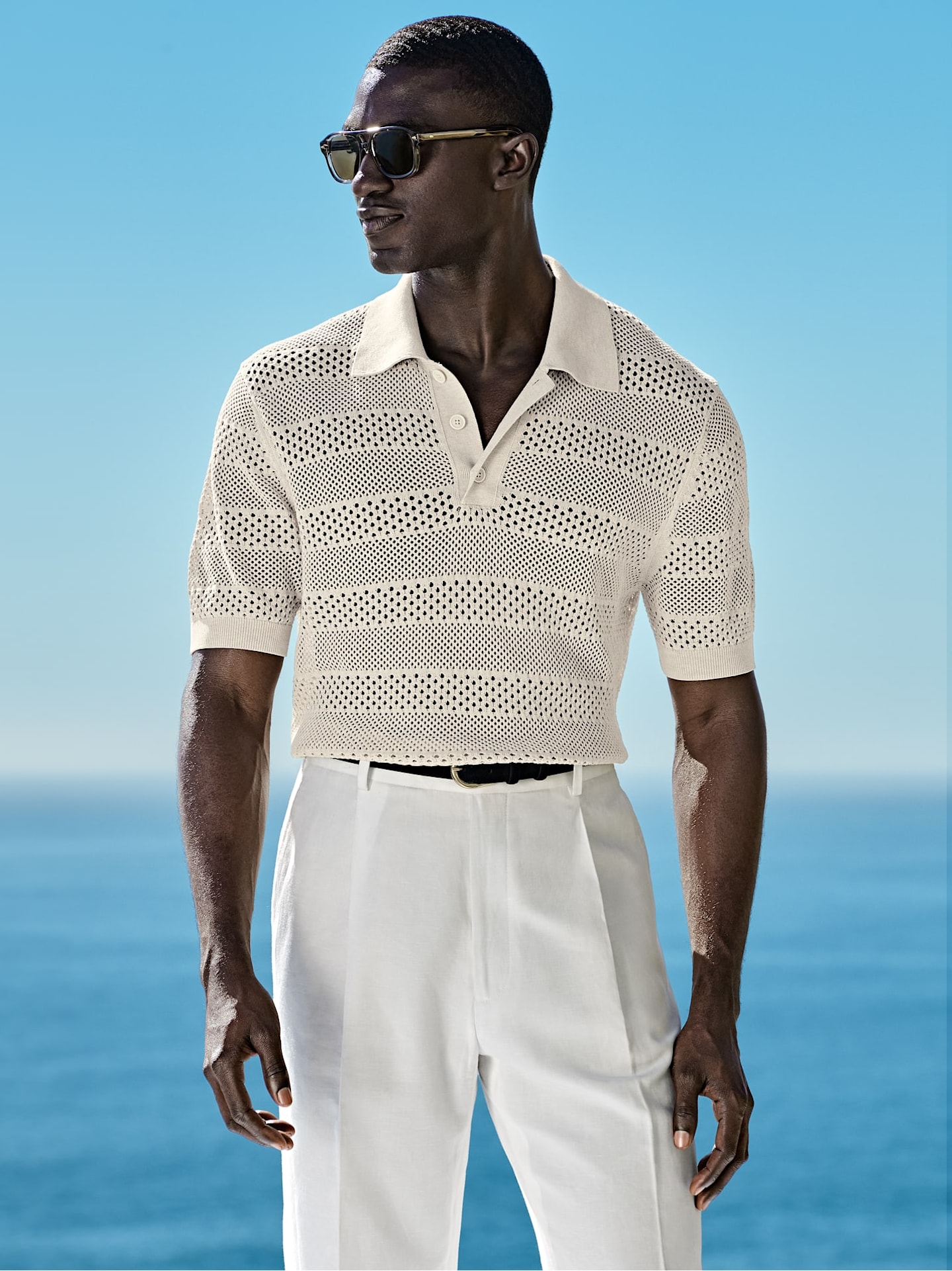 White open-knit polo styled with white trousers
