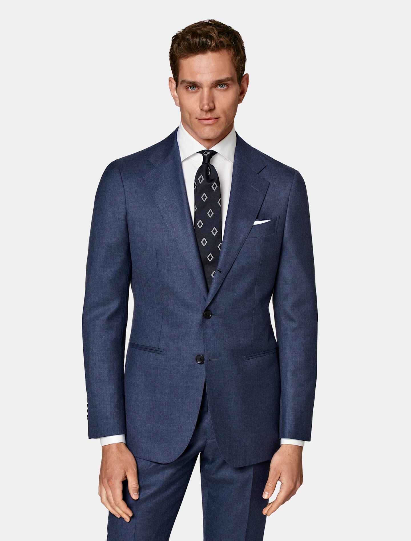 Blue single-breasted suit with white shirt and patterned tie.