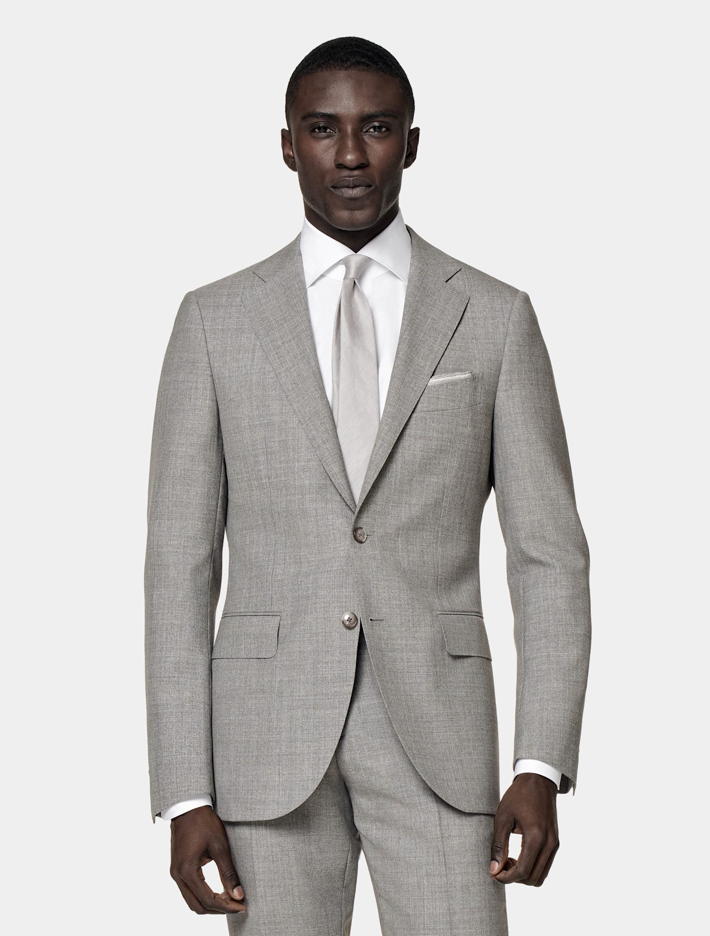Grey single-breasted suit with white shirt and grey silk tie.