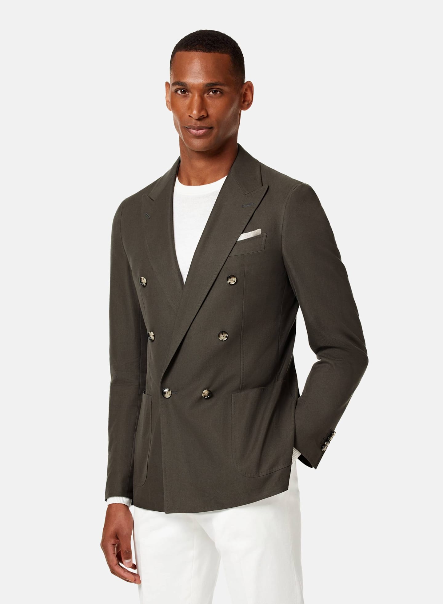 Man wearing a 6 on 2 low button closure double breasted jacket with a white handkerchief. 