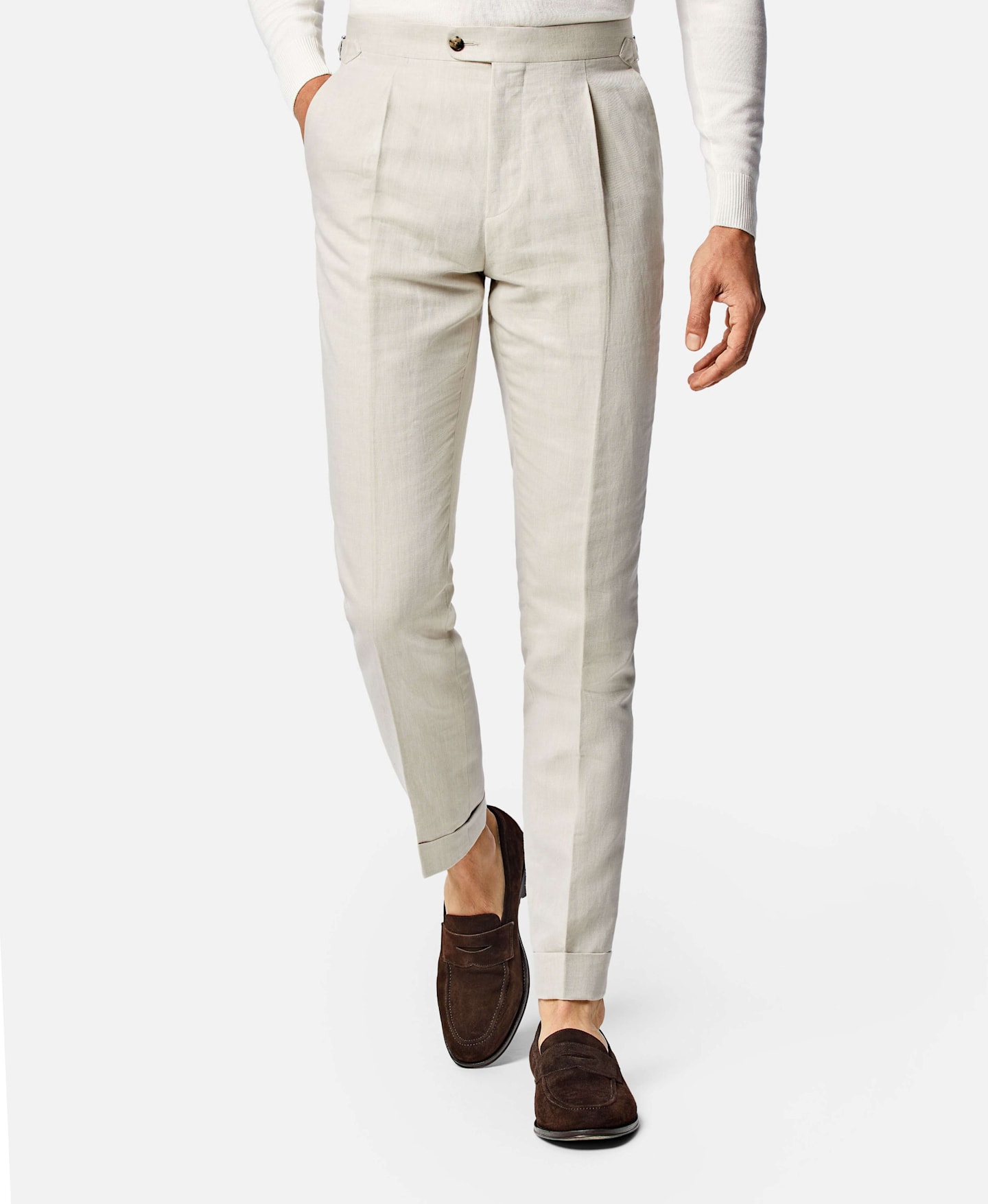 off-white linen single pleated pants paired with a brown loafer.