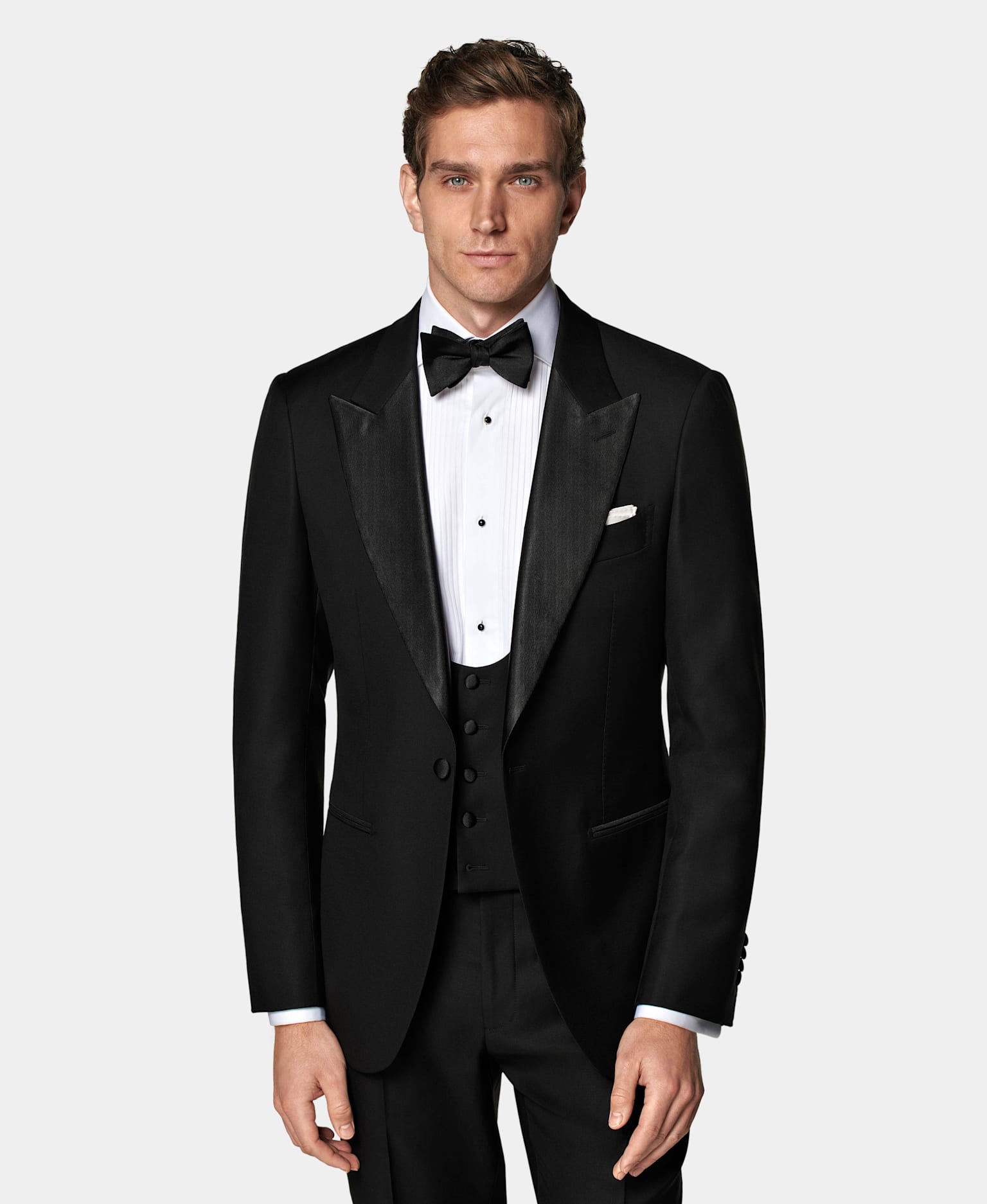 Black tuxedo with pleated shirt and black bow tie.