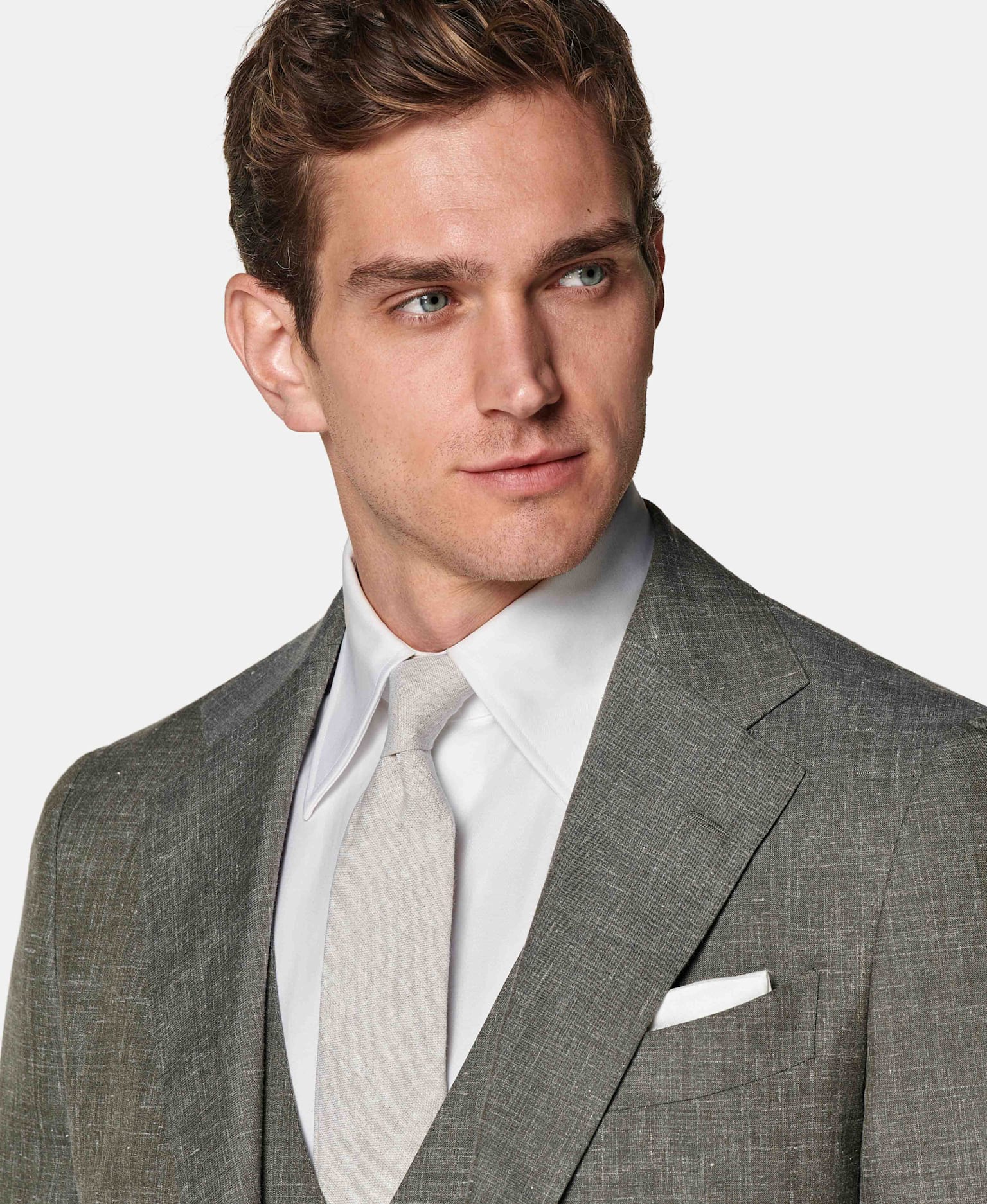 Mid-green three-piece suit with white shirt and light grey tie.