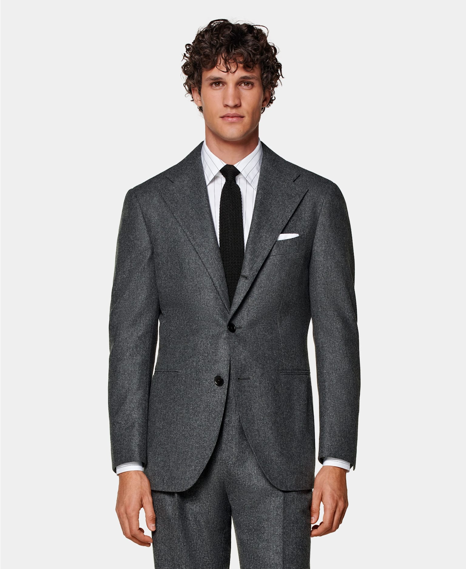 Dark grey single-breasted suit with white striped shirt and black knitted silk tie.