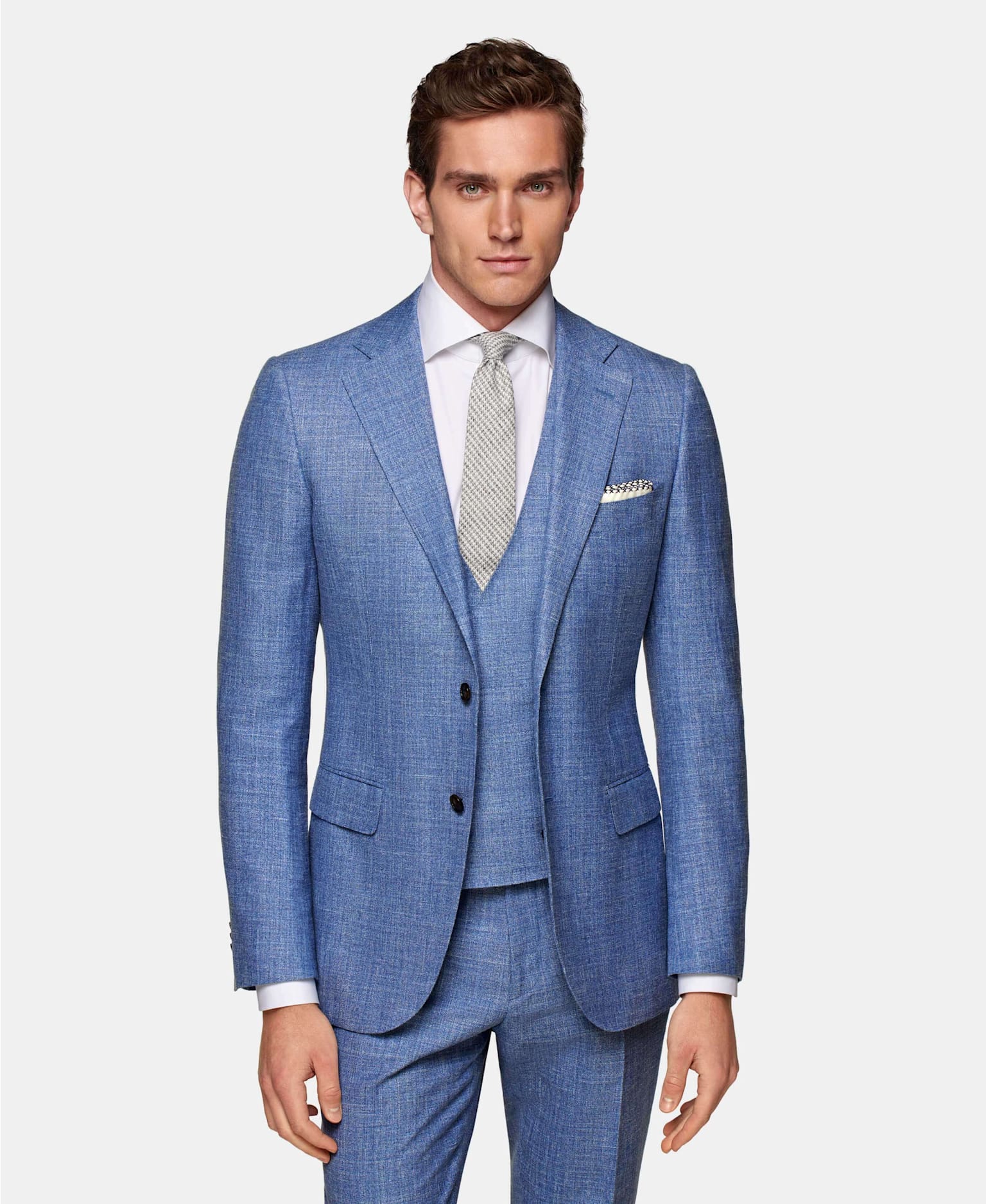 An image featuring Suitsupply’s light blue wool & silk linen blend suit, perfect for a summer wedding. 