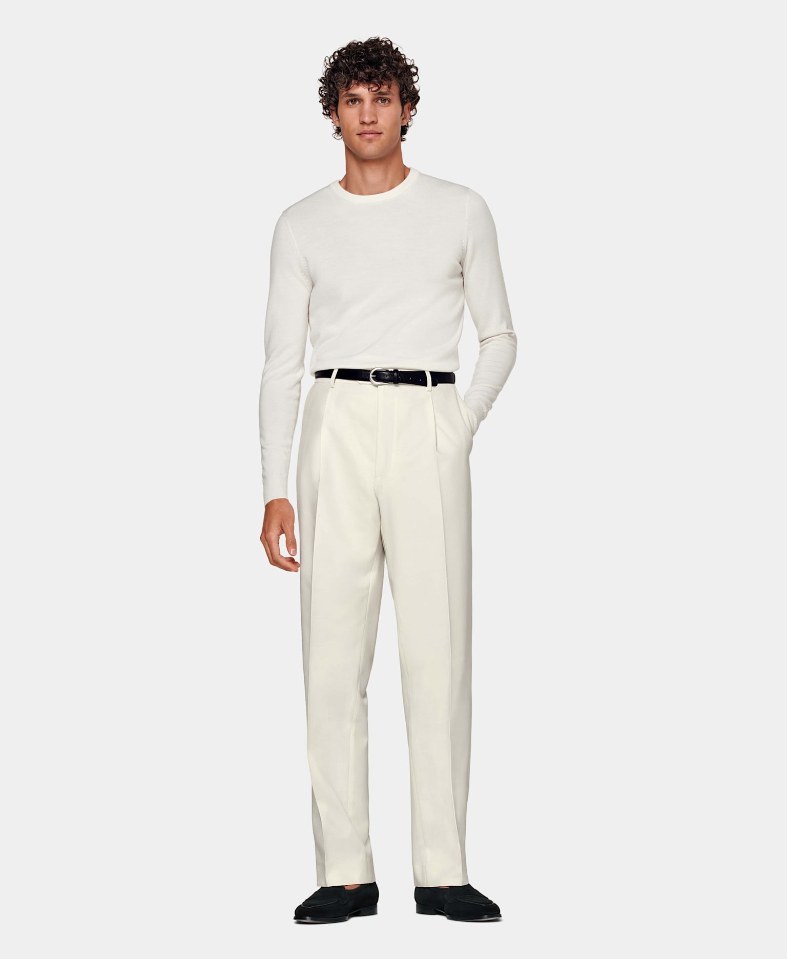 White & off-white sweater and straight-fight trouser combo with black belt and loafers.