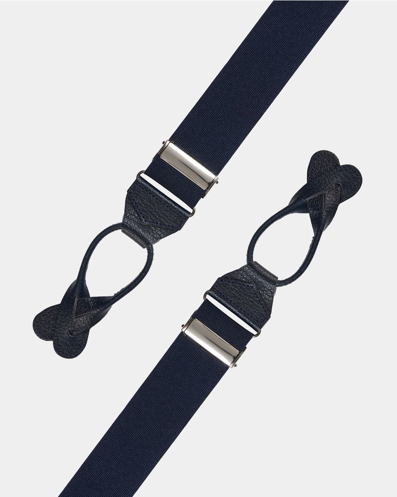 Suspenders with leather buckles.